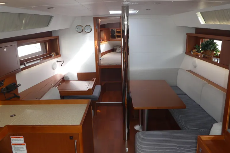  Yacht Photos Pics Interior of 2014 Beneteau Oceanis 41 sailboat with dining area and cozy seating.