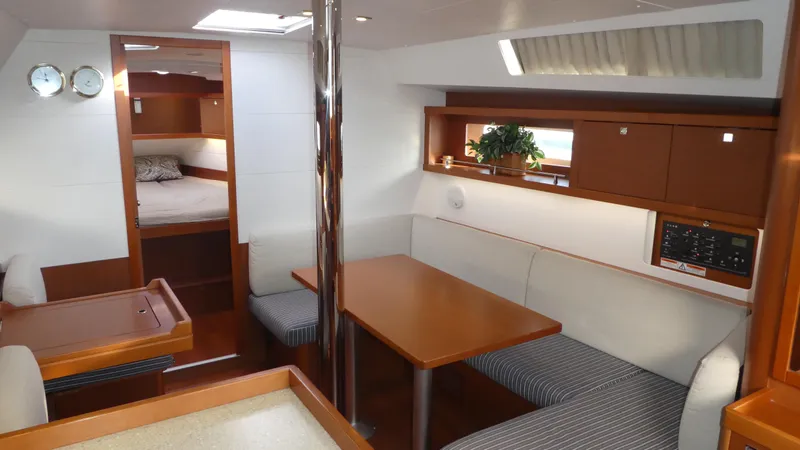  Yacht Photos Pics Interior of 2014 Beneteau Oceanis 41 sailboat with cozy dining area and cabin.