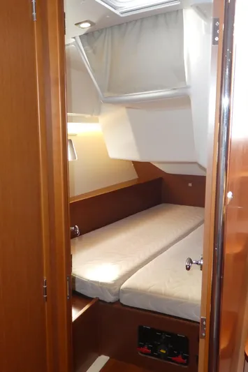  Yacht Photos Pics 2014 Beneteau Oceanis 41 cabin interior with cozy bed and wooden finish.