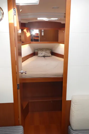  Yacht Photos Pics 2014 Beneteau Oceanis 41 cabin interior with cozy bed and wooden finish.