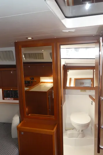  Yacht Photos Pics Interior of 2014 Beneteau Oceanis 41 yacht, featuring a compact bathroom and wooden cabinetry.