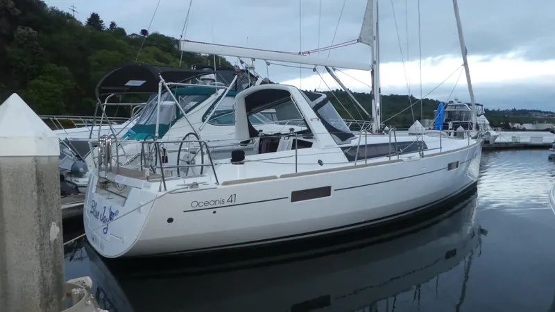  Yacht Photos Pics 2014 Beneteau Oceanis 41 sailboat docked in a marina, side view.
