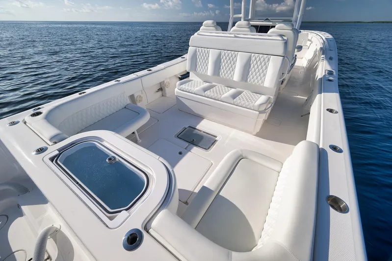  Yacht Photos Pics 2022 Invincible 39 Open Fisherman boat with luxurious seating on calm ocean waters.