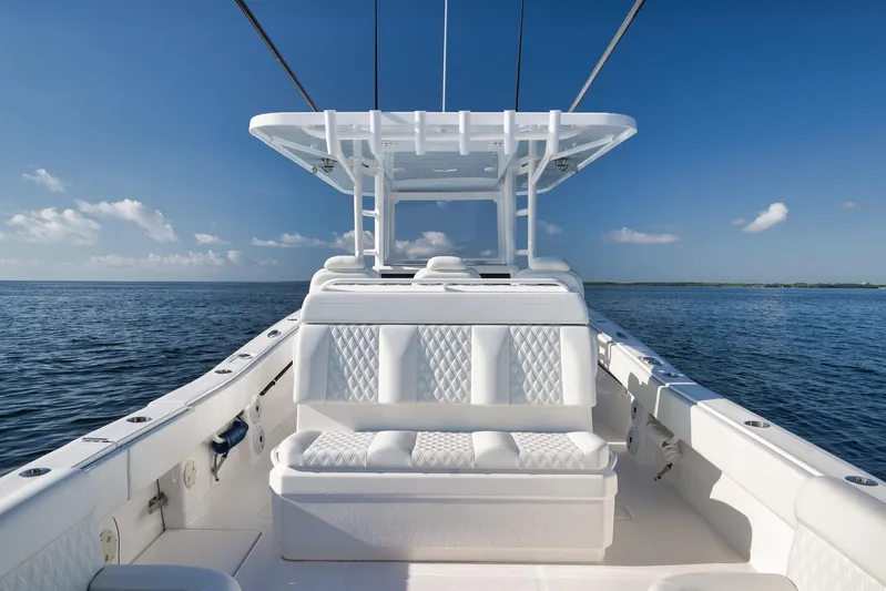  Yacht Photos Pics 2022 Invincible 39 Open Fisherman boat on calm ocean waters under clear blue sky.