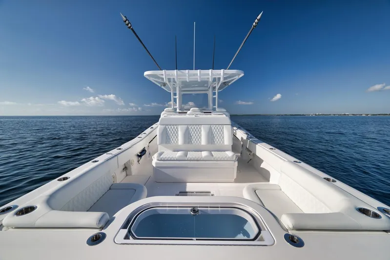  Yacht Photos Pics 2022 Invincible 39 Open Fisherman boat on calm ocean waters under clear blue sky.