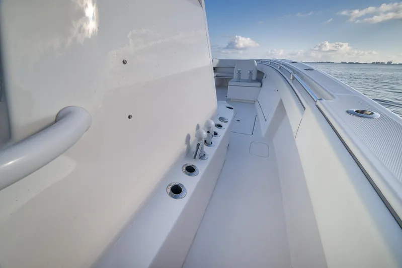  Yacht Photos Pics 2022 Invincible 39 Open Fisherman boat deck with rod holders, ocean view.