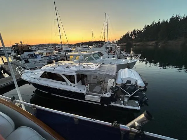  Yacht Photos Pics 2024 Cutwater C-32 C boat docked at sunset in a serene marina.
