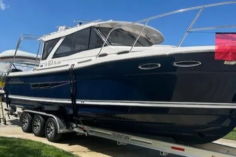  Yacht Photos Pics 2024 Cutwater C-32 C boat on trailer, sleek design, blue hull, sunny day.