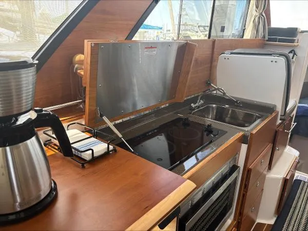  Yacht Photos Pics 2024 Cutwater C-32 C yacht kitchen with stove, sink, and coffee maker.