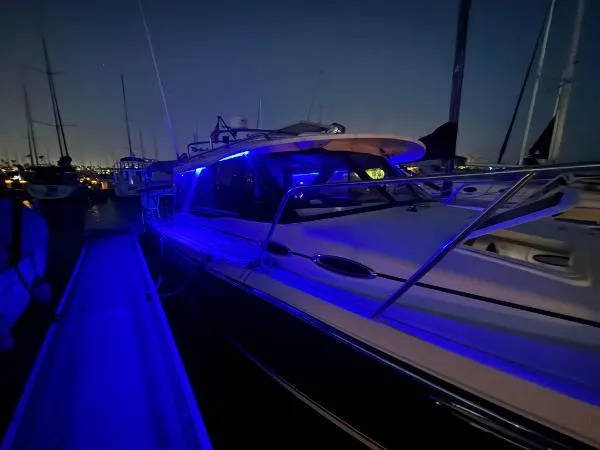  Yacht Photos Pics 2024 Cutwater C-32 C boat docked at night with blue LED lights.
