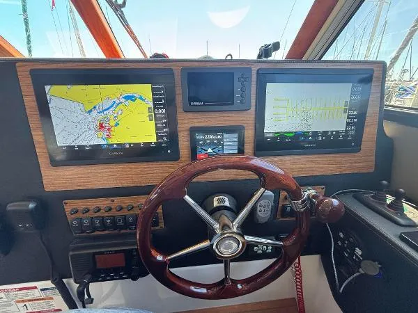  Yacht Photos Pics 2024 Cutwater C-32 C helm with navigation screens and wooden steering wheel.