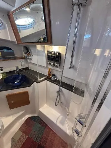  Yacht Photos Pics 2024 Cutwater C-32 C bathroom with modern shower, sink, and storage.