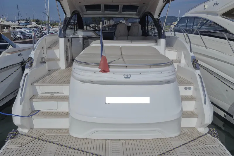  Yacht Photos Pics 2024 Princess V50 yacht docked at marina, showcasing spacious deck and seating area.