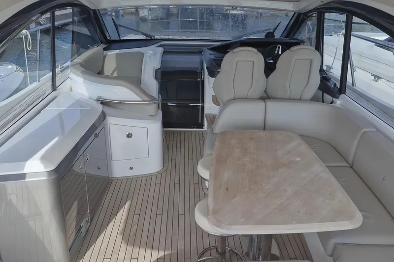  Yacht Photos Pics Luxurious interior of 2024 Princess V50 yacht with elegant seating and wooden table.