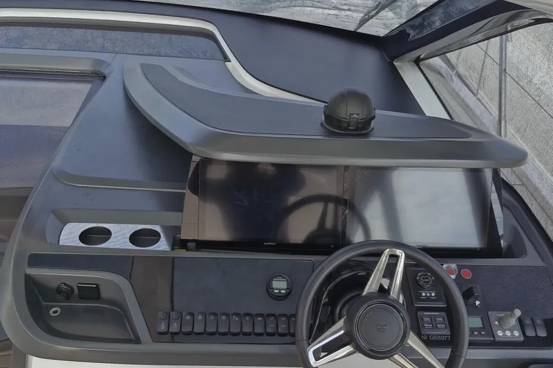  Yacht Photos Pics 2024 Princess V50 yacht dashboard with steering wheel and navigation controls.