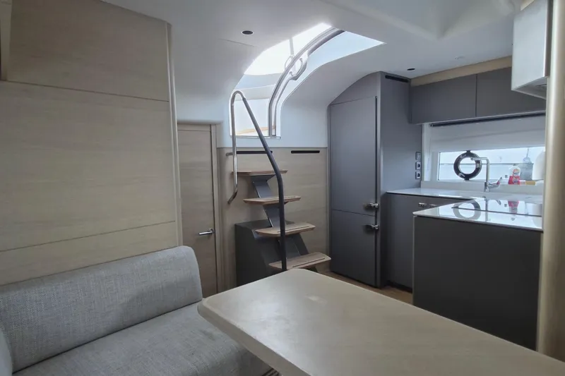  Yacht Photos Pics Modern interior of 2024 Princess V50 yacht with sleek kitchen and stylish staircase.