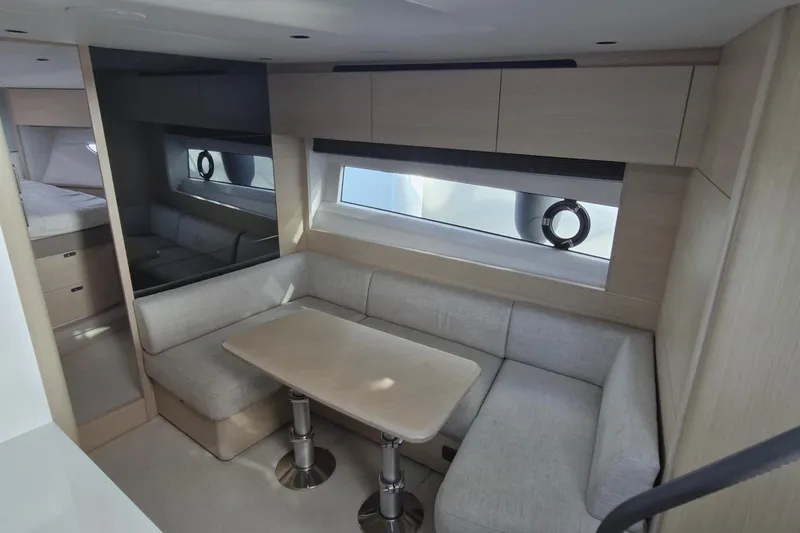  Yacht Photos Pics Luxurious interior of 2024 Princess V50 yacht with modern seating and table.