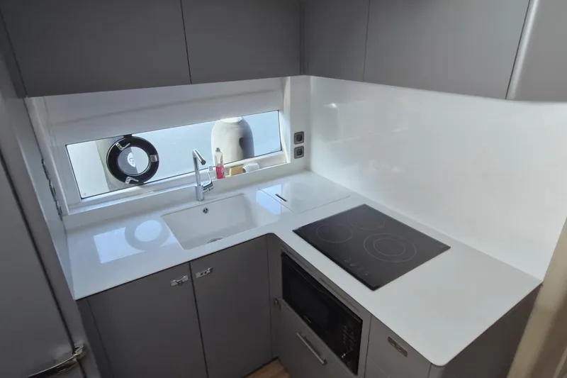  Yacht Photos Pics Modern kitchen in 2024 Princess V50 yacht with sleek design and appliances.