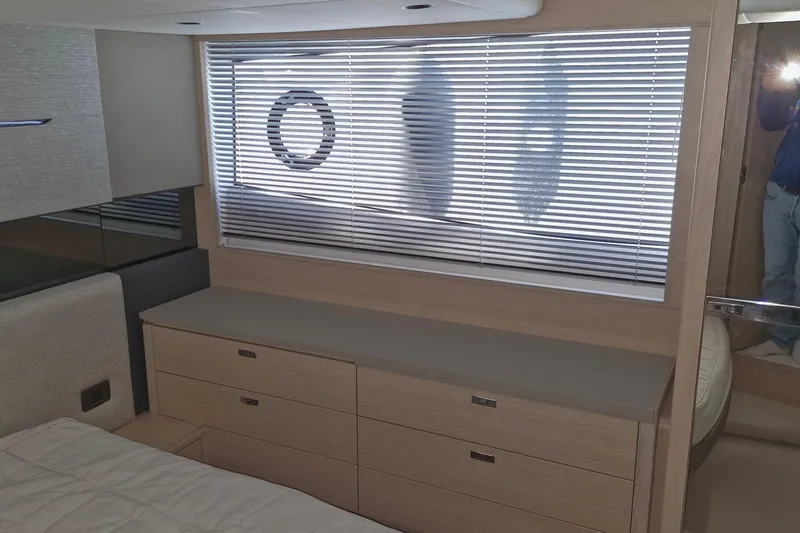  Yacht Photos Pics 2024 Princess V50 yacht interior with modern cabinetry and window blinds.