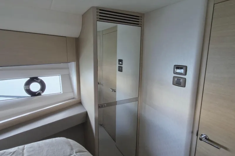  Yacht Photos Pics 2024 Princess V50 yacht interior with modern design, featuring a mirror and window.