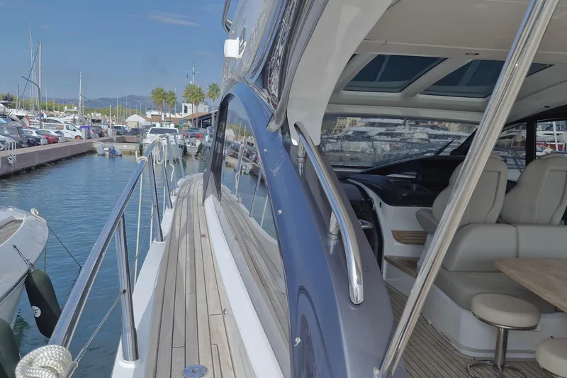  Yacht Photos Pics 2024 Princess V50 yacht docked at marina, showcasing sleek design and luxurious interior.