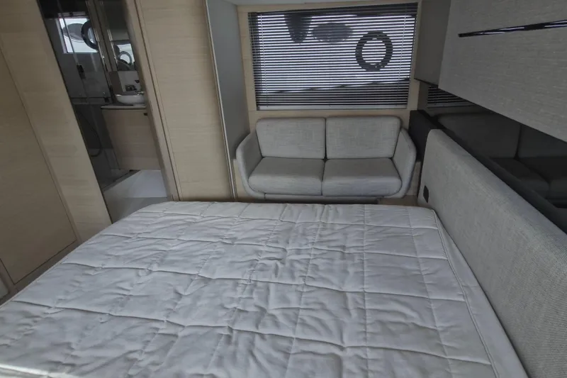  Yacht Photos Pics 2024 Princess V50 yacht interior with bed, sofa, and modern decor.