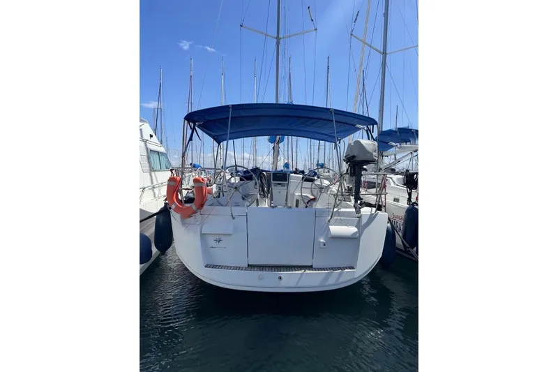  Yacht Photos Pics 2015 Jeanneau Sun Odyssey 409 sailboat docked with blue canopy and lifebuoys.