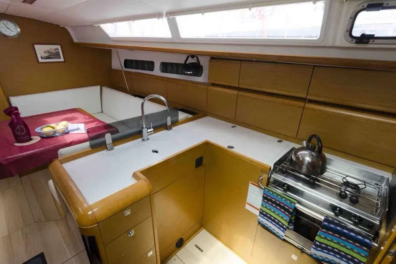  Yacht Photos Pics Interior of 2015 Jeanneau Sun Odyssey 409 yacht with modern kitchen and dining area.