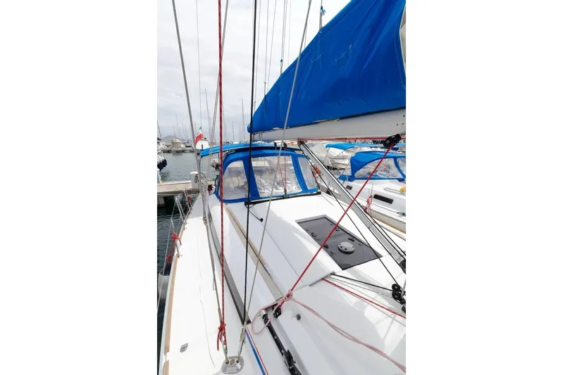  Yacht Photos Pics 2015 Jeanneau Sun Odyssey 409 sailboat docked, featuring blue sail cover and rigging.