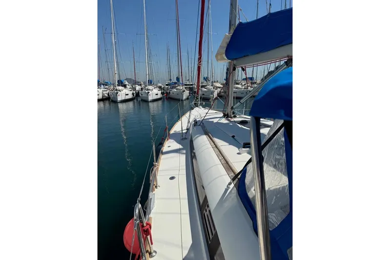  Yacht Photos Pics 2015 Jeanneau Sun Odyssey 409 sailboat docked in a marina, surrounded by other yachts.