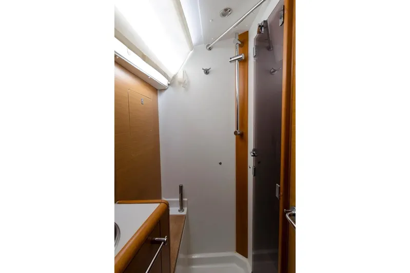  Yacht Photos Pics Bathroom interior of 2015 Jeanneau Sun Odyssey 409 yacht, featuring modern shower design.