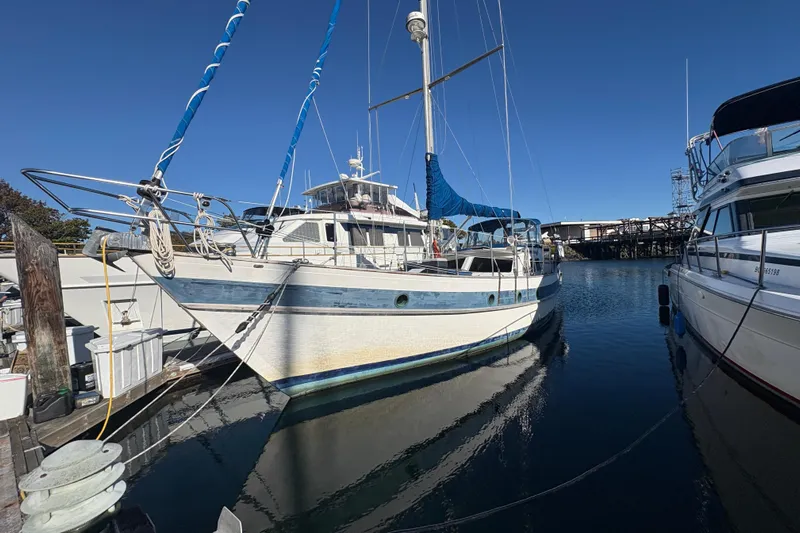 Tenacious Yacht Photos Pics 1987 Mikelson 50 sailboat docked in marina under clear blue sky.