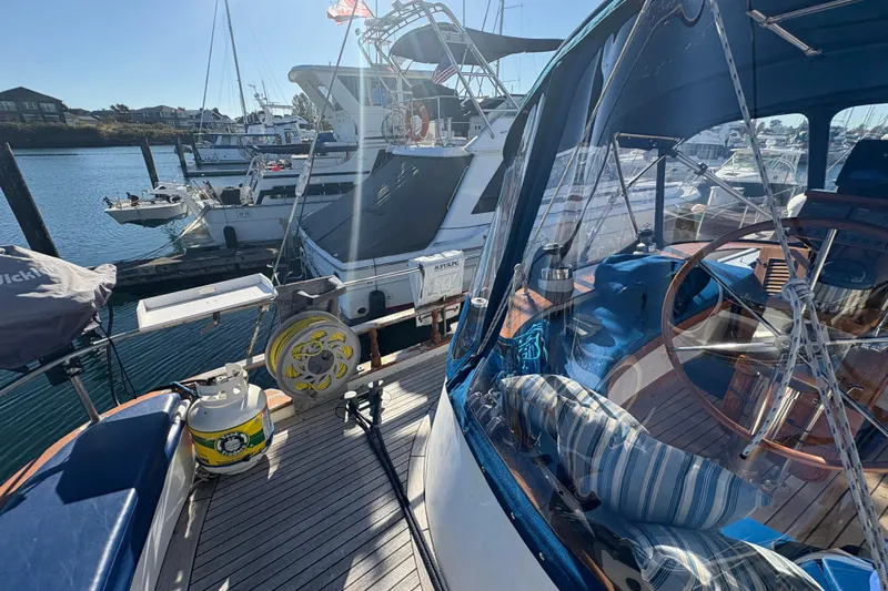 Tenacious Yacht Photos Pics 1987 Mikelson 50 yacht docked at marina, featuring a cozy cockpit and nautical decor.