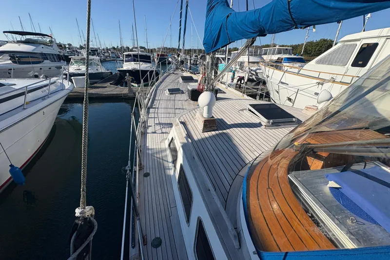 Tenacious Yacht Photos Pics 1987 Mikelson 50 yacht docked in marina, surrounded by other boats.