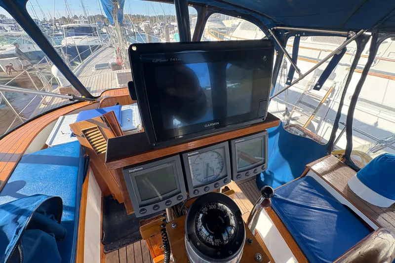 Tenacious Yacht Photos Pics Cockpit of 1987 Mikelson 50 yacht with navigation instruments and compass.
