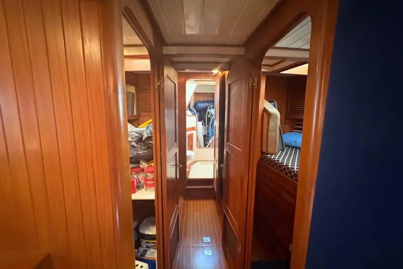 Tenacious Yacht Photos Pics Interior of 1987 Mikelson 50 yacht with wooden paneling and cozy cabin spaces.