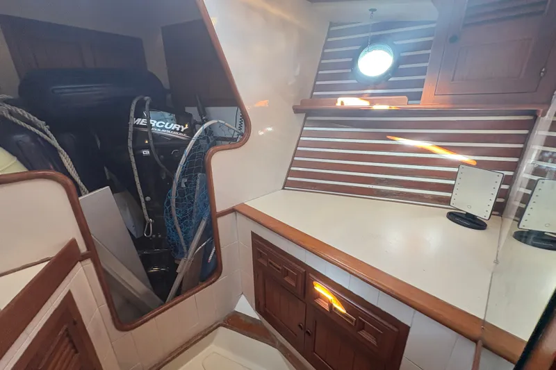 Tenacious Yacht Photos Pics Interior of 1987 Mikelson 50 boat with wooden cabinets and Mercury engine.