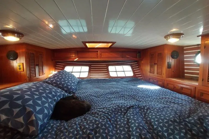Tenacious Yacht Photos Pics Cozy cabin interior of 1987 Mikelson 50 yacht with patterned bedding and wooden accents.