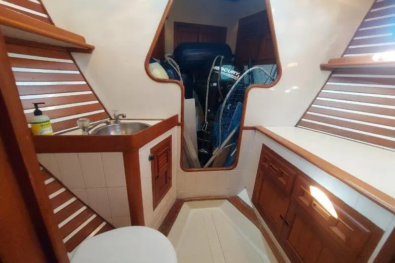 Tenacious Yacht Photos Pics Interior of a 1987 Mikelson 50 boat with wooden cabinetry and a small sink.