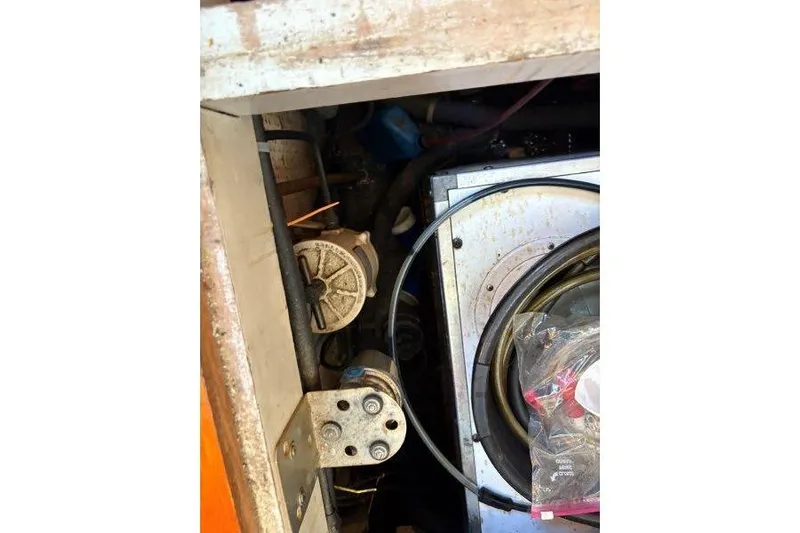 Tenacious Yacht Photos Pics Engine compartment of a 1987 Mikelson 50 boat, showing mechanical components and wiring.