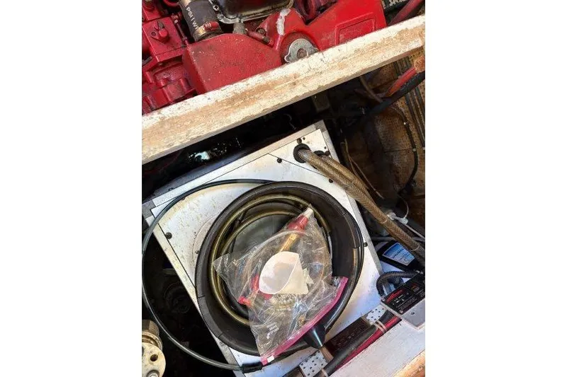 Tenacious Yacht Photos Pics Engine compartment of a 1987 Mikelson 50 boat with cables and equipment.