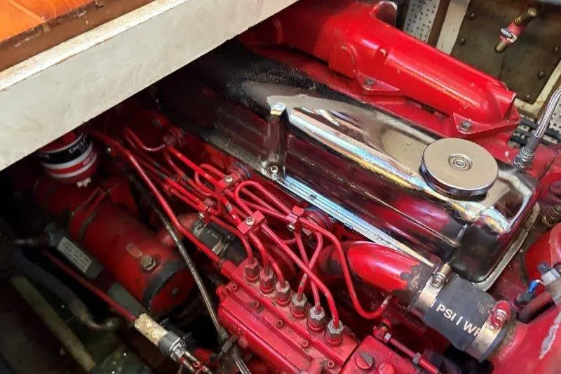 Tenacious Yacht Photos Pics Engine compartment of a 1987 Mikelson 50, featuring red and chrome components.