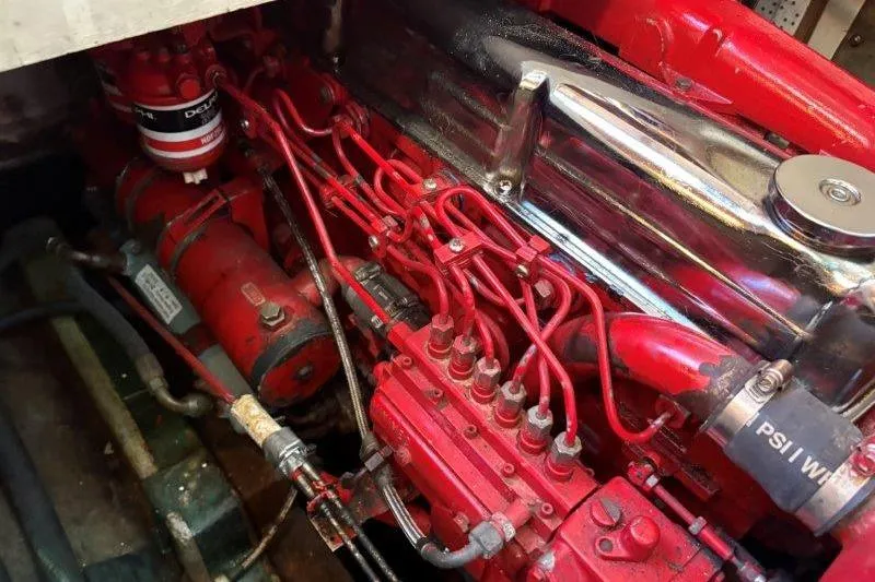 Tenacious Yacht Photos Pics Engine of a 1987 Mikelson 50 boat, featuring red components and intricate wiring.