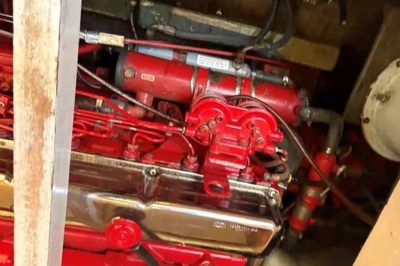 Tenacious Yacht Photos Pics Engine of a 1987 Mikelson 50 boat, featuring red components and intricate wiring.