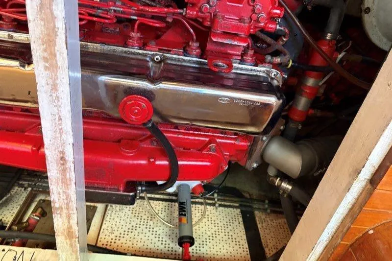 Tenacious Yacht Photos Pics Engine compartment of a 1987 Mikelson 50 boat, featuring a red engine.