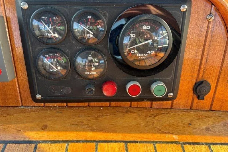 Tenacious Yacht Photos Pics Control panel of a 1987 Mikelson 50 boat with gauges and buttons.