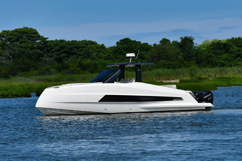  Yacht Photos Pics 2023 Astondoa 377 Coupe Outboard yacht cruising on a serene lake with lush greenery.