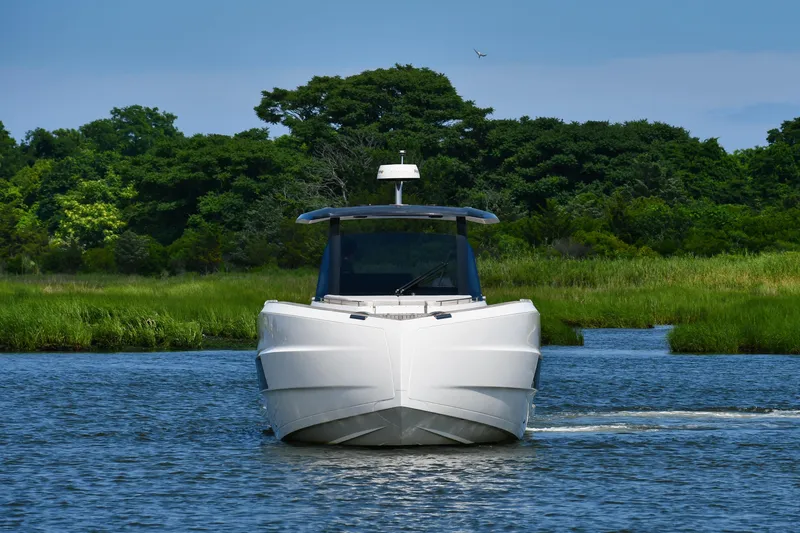 Yacht Photos Pics 2023 Astondoa 377 Coupe Outboard cruising on a serene river with lush greenery.