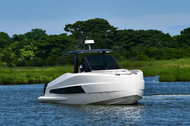  Yacht Photos Pics 2023 Astondoa 377 Coupe Outboard cruising on a serene river with lush greenery.