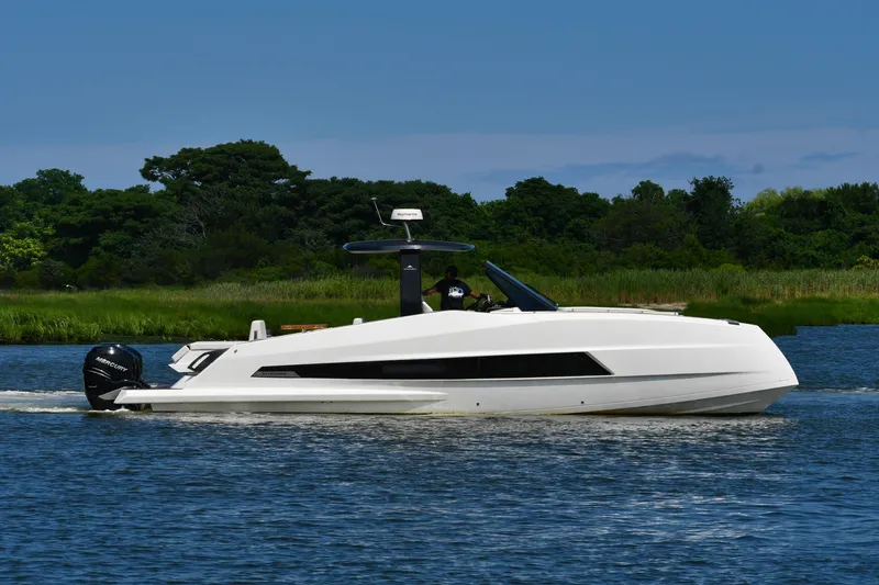  Yacht Photos Pics 2023 Astondoa 377 Coupe Outboard cruising on a serene waterway with lush greenery.